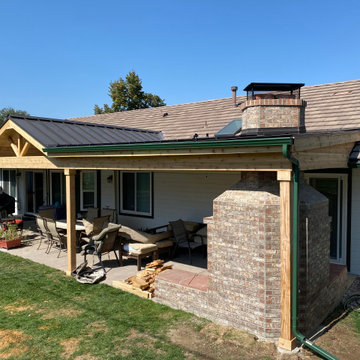 Patio roof cover with brick fireplace.