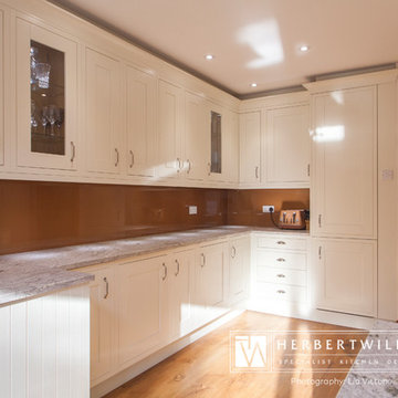 Ivory Mackintosh kitchen with stunning copper glass splashback