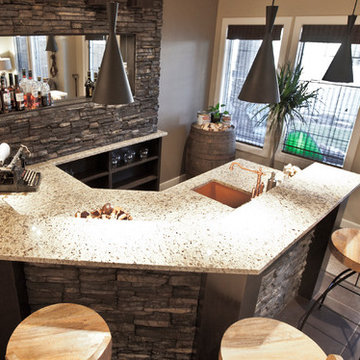 Stone basement wetbar and dark wood cabinetry