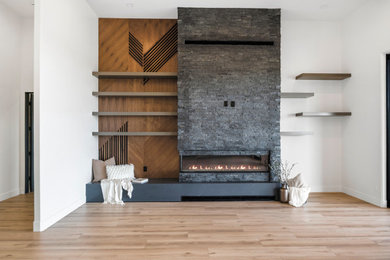 Living room - contemporary open concept vinyl floor and wood wall living room idea in Phoenix with white walls and a stone fireplace