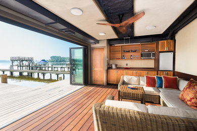 Water fountain deck - small coastal backyard water fountain deck idea in DC Metro with a roof extension