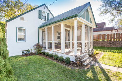 Mid-sized trendy screened-in back porch idea in Minneapolis with decking and a roof extension