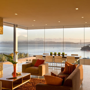 Modern inredning av ett stort allrum med öppen planlösning, med en bred öppen spis, travertin golv och en spiselkrans i sten