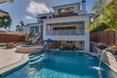 Pool fountain - large traditional backyard stone and custom-shaped infinity pool fountain idea in Los Angeles