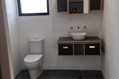 Photo of a small contemporary master bathroom in Perth with furniture-like cabinets, black cabinets, white tile and ceramic tile.