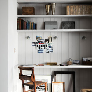 Design ideas for a small industrial study in London with a built-in desk, grey walls and dark hardwood flooring.