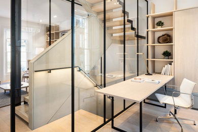 Inspiration for a medium sized scandi study in London with white walls, light hardwood flooring, a freestanding desk and brown floors.