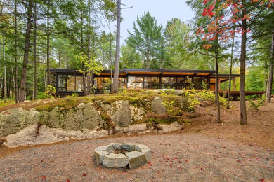 Inspiration for a large contemporary brown one-story glass exterior home remodel in Toronto