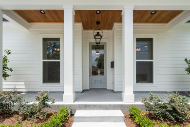 Inspiration for a mid-sized transitional concrete front porch remodel in New Orleans