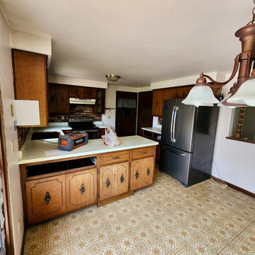 Photo 3 – Original Cabinetry & Layout Outdated cabinetry and countertop configur