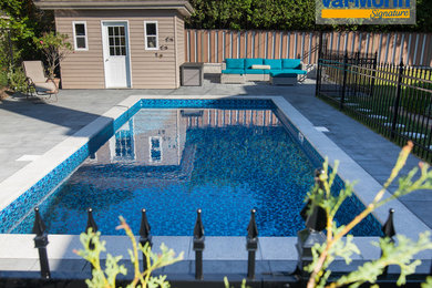 Inspiration for a mid-sized timeless backyard concrete paver and rectangular pool remodel in Montreal