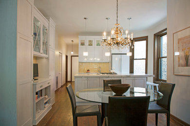 Mid-sized transitional l-shaped medium tone wood floor eat-in kitchen photo in Chicago with an undermount sink, shaker cabinets, white cabinets, quartz countertops, yellow backsplash, ceramic backsplash, white appliances and an island