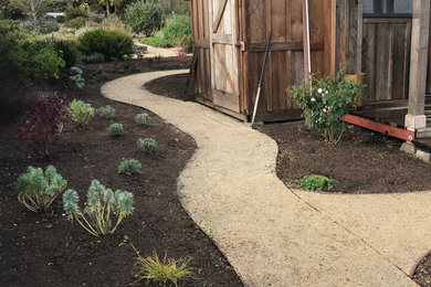 Photo of a huge farmhouse drought-tolerant backyard decomposed granite and stone fence garden path in Other.