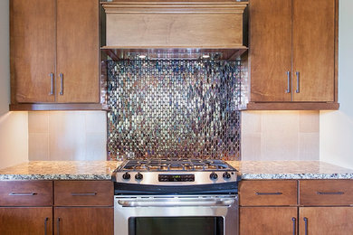Example of a classic l-shaped eat-in kitchen design in Other with brown cabinets, granite countertops, multicolored backsplash, mosaic tile backsplash, stainless steel appliances and an island