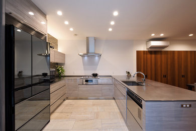 Design ideas for a contemporary u-shaped open plan kitchen in Other with a single-bowl sink, flat-panel cabinets, grey cabinets and beige floor.