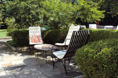 Example of a large classic backyard stone patio design in New York