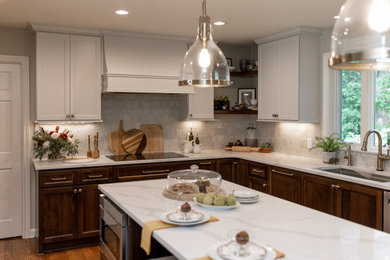 Inspiration for a mid-sized transitional l-shaped medium tone wood floor and brown floor eat-in kitchen remodel in Other with an undermount sink, recessed-panel cabinets, medium tone wood cabinets, quartz countertops, beige backsplash, terra-cotta backsplash, stainless steel appliances, an island and white countertops