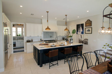 Inspiration for a mid-sized coastal l-shaped ceramic tile and beige floor eat-in kitchen remodel in Tampa with an integrated sink, recessed-panel cabinets, white cabinets, quartzite countertops, white backsplash, ceramic backsplash, stainless steel appliances and an island