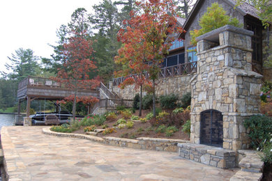 Large mountain style brown two-story mixed siding exterior home photo in Other