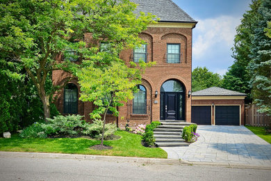 Photo of a transitional front yard stone landscaping in Toronto.