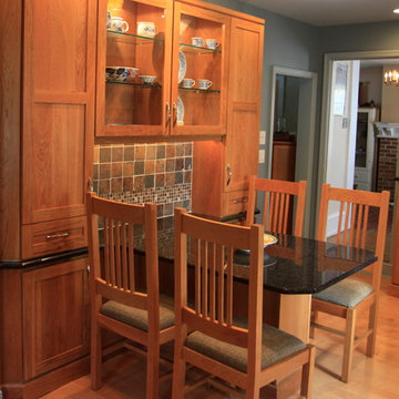 Cohesive Transitional Kitchen | Cherry Cabinets & Black Granite Table