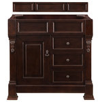 James Martin - Brookfield 36" Burnished Mahogany Single Vanity - The Brookfield 36" Burnished Mahogany vanity by James Martin Vanities features hand carved accenting filigrees and raised panel doors. One door opens to shelves for storage below and two drawers, made up of a lower double-height drawer and a middle standard drawer, offer additional storage space. The look is completed with Antique Brass finish door and drawer pulls. Matching decorative wood backsplash is included.