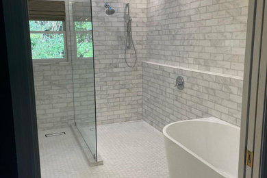 Example of a minimalist multicolored tile doorless shower design in Other