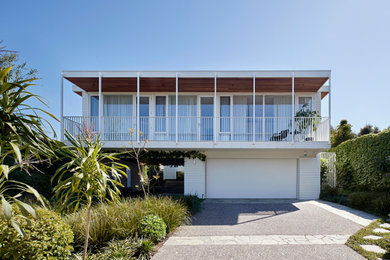 Inspiration for a large midcentury two-storey brick house exterior in Melbourne.