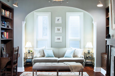 Example of a classic enclosed dark wood floor living room design in Chicago with gray walls
