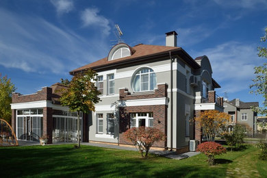 Transitional multicolored two-story house exterior idea in Moscow with a hip roof