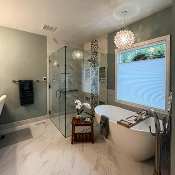 Primary Bath with Marble Look Tiled Shower and Free Standing Tub