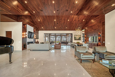 Living room - modern open concept wood ceiling and wood wall living room idea in Orlando with brown walls