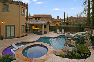 Example of a large transitional backyard stone and custom-shaped water slide design in San Francisco