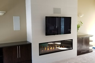 Living room - mid-sized contemporary open concept carpeted and gray floor living room idea in Omaha with a standard fireplace, a tile fireplace and a wall-mounted tv