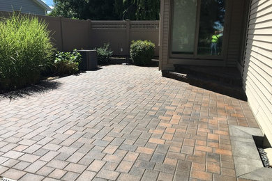 Patio - mid-sized traditional backyard brick patio idea in Providence with no cover