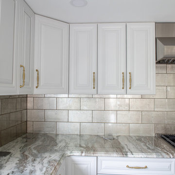 Transitional Kitchen Done in a 2 Tone Color With Integrated Dining Table