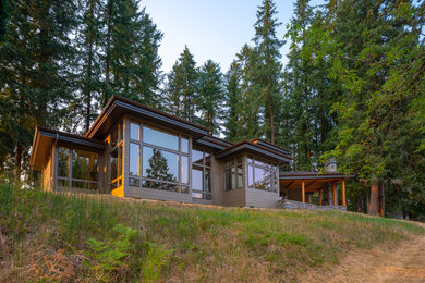 Large transitional brown two-story concrete fiberboard house exterior photo in Portland with a shingle roof
