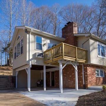 Rear view of sunroom with deck