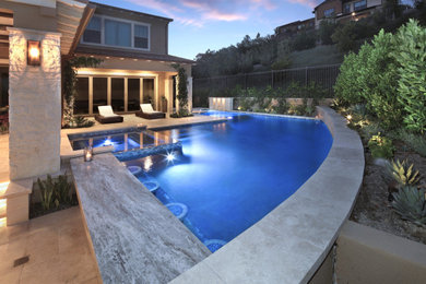 Pool fountain - mid-sized coastal stone and l-shaped pool fountain idea
