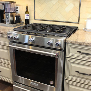 Farmhouse kitchen Taupe Painted Cabinets,Quartz Tops, and Dark Island