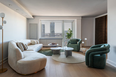 Example of a minimalist light wood floor living room design with white walls