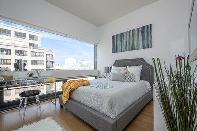 Bedroom - mid-sized contemporary master medium tone wood floor bedroom idea in New York with gray walls and no fireplace