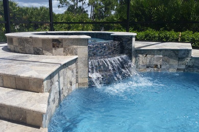 Inspiration for a mid-sized modern backyard stone and kidney-shaped pool remodel in Miami