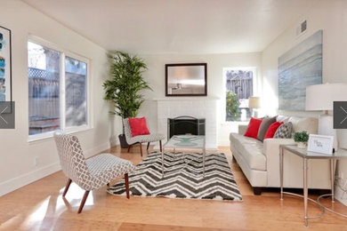 Mid-sized transitional formal and enclosed light wood floor and brown floor living room photo in San Francisco with white walls, a standard fireplace, a brick fireplace and no tv
