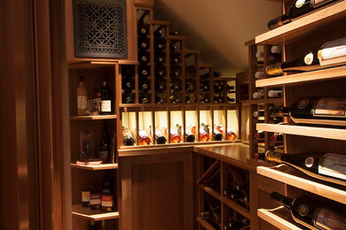 Example of a transitional medium tone wood floor wine cellar design in Toronto