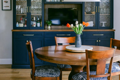 Small elegant medium tone wood floor dining room photo in San Diego with beige walls