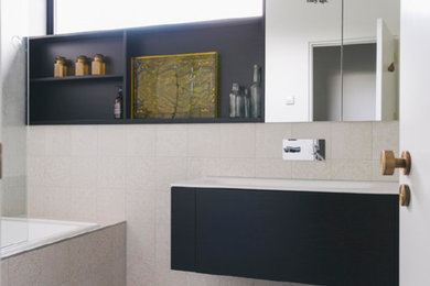 Small eclectic bathroom in Auckland with open cabinets, black cabinets, an alcove tub, a shower/bathtub combo, beige tile, ceramic tile, white walls, ceramic floors, a drop-in sink and an open shower.