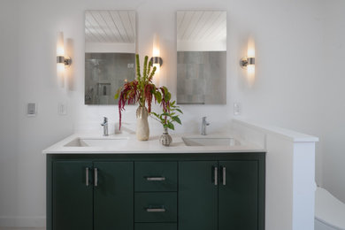 Inspiration for a mid-sized master multicolored tile and porcelain tile porcelain tile, beige floor, double-sink and shiplap ceiling drop-in bathtub remodel in San Francisco with flat-panel cabinets, green cabinets, a one-piece toilet, white walls, an undermount sink, white countertops, a niche, a freestanding vanity and a hinged shower door