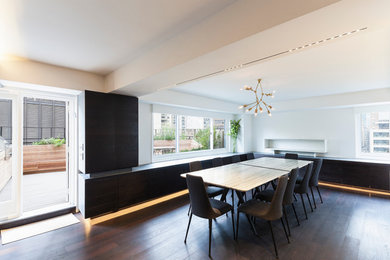 Mid-sized trendy dark wood floor kitchen/dining room combo photo in New York with white walls and no fireplace