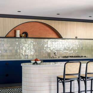 This is an example of a large contemporary galley open plan kitchen in Sydney with an undermount sink, flat-panel cabinets, blue cabinets, quartz benchtops, green splashback, ceramic splashback, stainless steel appliances, light hardwood floors, with island, grey floor and grey benchtop.